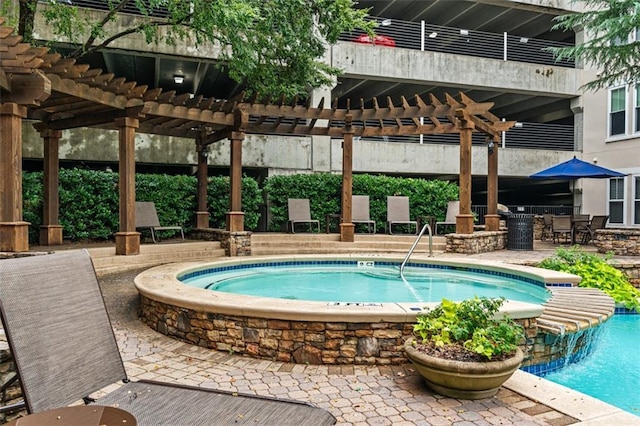 swimming pool featuring a pergola, a community hot tub, and a patio