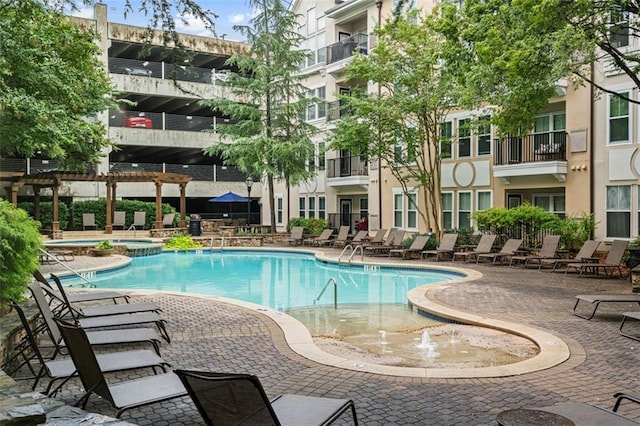 community pool featuring a hot tub and a patio