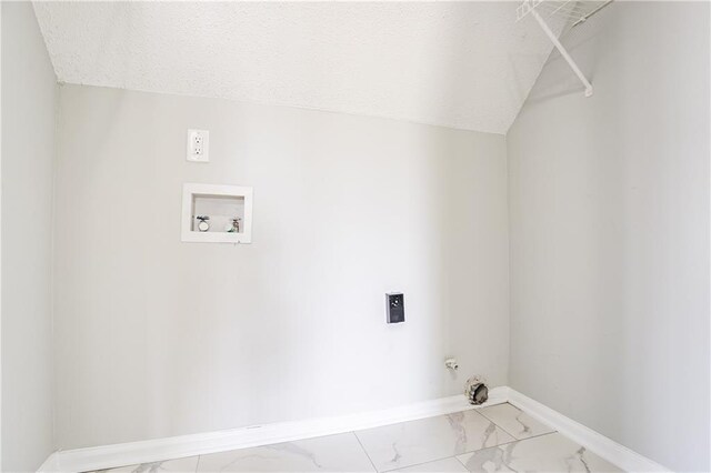laundry area with hookup for a washing machine, baseboards, a textured ceiling, marble finish floor, and laundry area