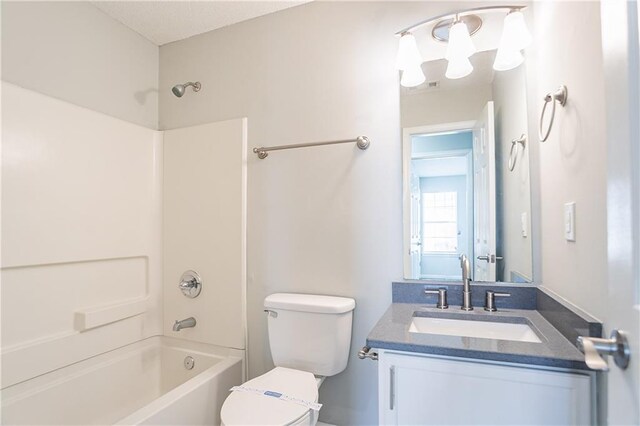 full bathroom featuring toilet, vanity, and  shower combination