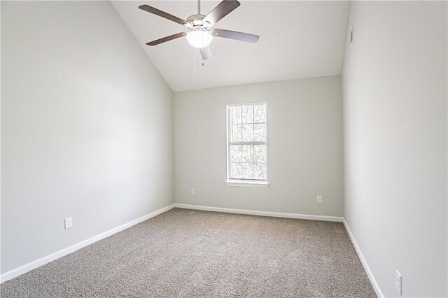 empty room with visible vents, baseboards, ceiling fan, carpet floors, and vaulted ceiling