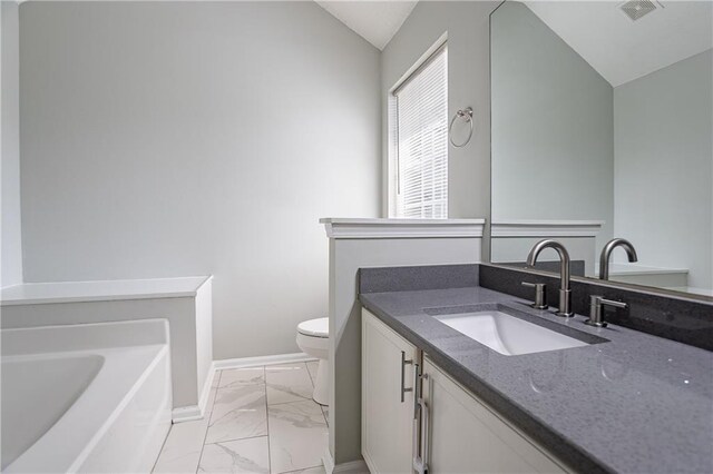 bathroom featuring vanity, lofted ceiling, marble finish floor, baseboards, and visible vents