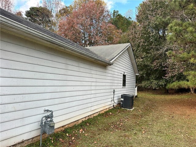 view of property exterior featuring a yard and central AC