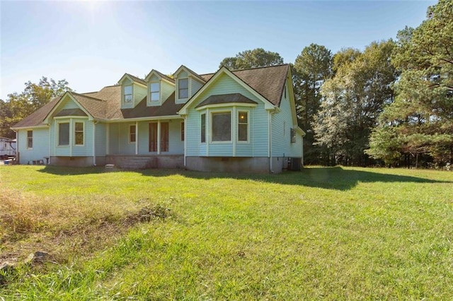 view of front of property with a front lawn and central AC unit