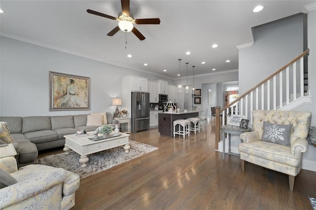 living room featuring crown molding, dark hardwood / wood-style floors, and ceiling fan