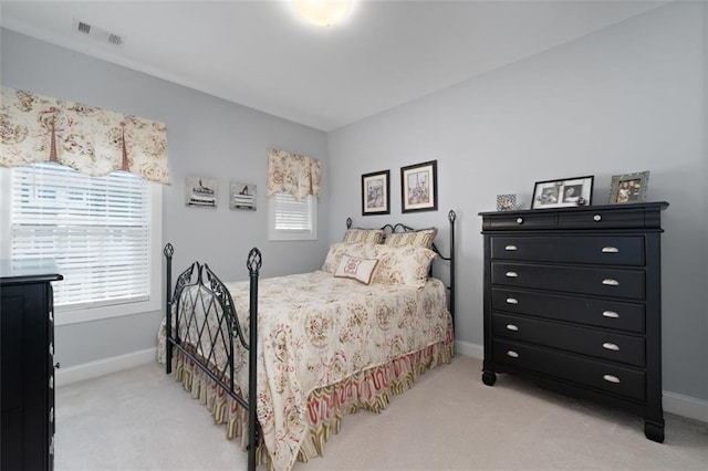 carpeted bedroom with multiple windows