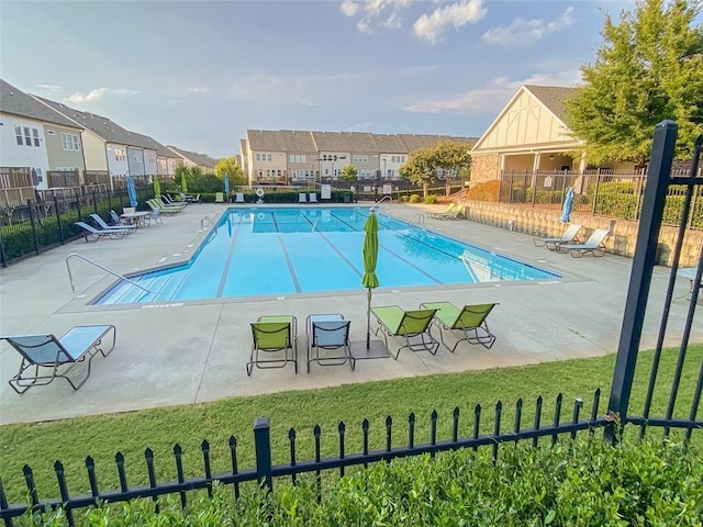 view of pool featuring a lawn and a patio