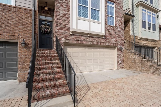 doorway to property with a garage