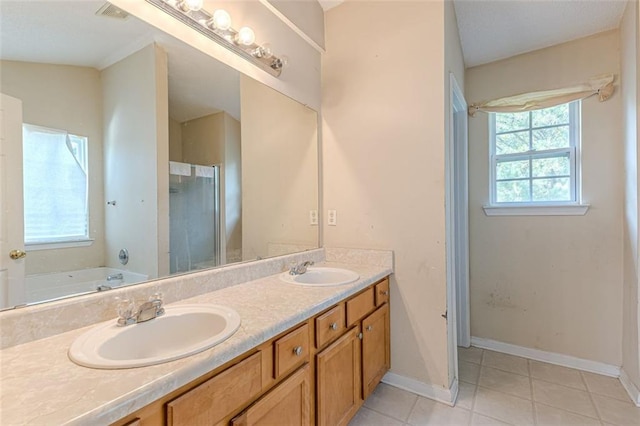 bathroom with plenty of natural light, vanity, lofted ceiling, and tile patterned flooring