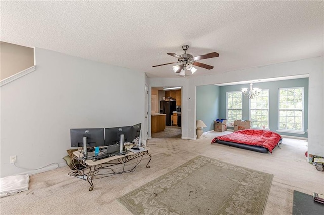 carpeted bedroom featuring ceiling fan with notable chandelier, a textured ceiling, and black refrigerator