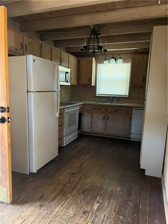 kitchen featuring beamed ceiling, sink, dark hardwood / wood-style flooring, a chandelier, and white appliances