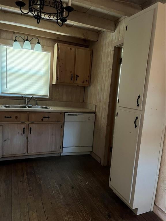 kitchen with sink, dark wood-type flooring, beam ceiling, white dishwasher, and wood walls