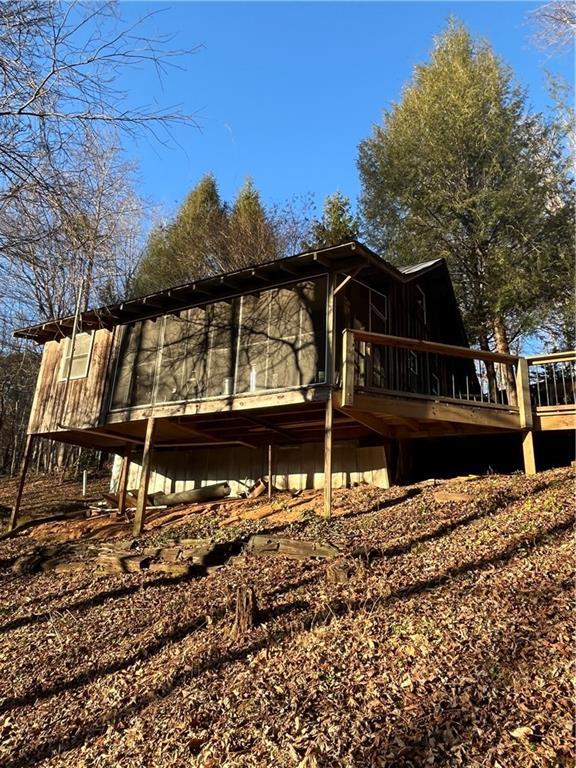 rear view of house with a wooden deck