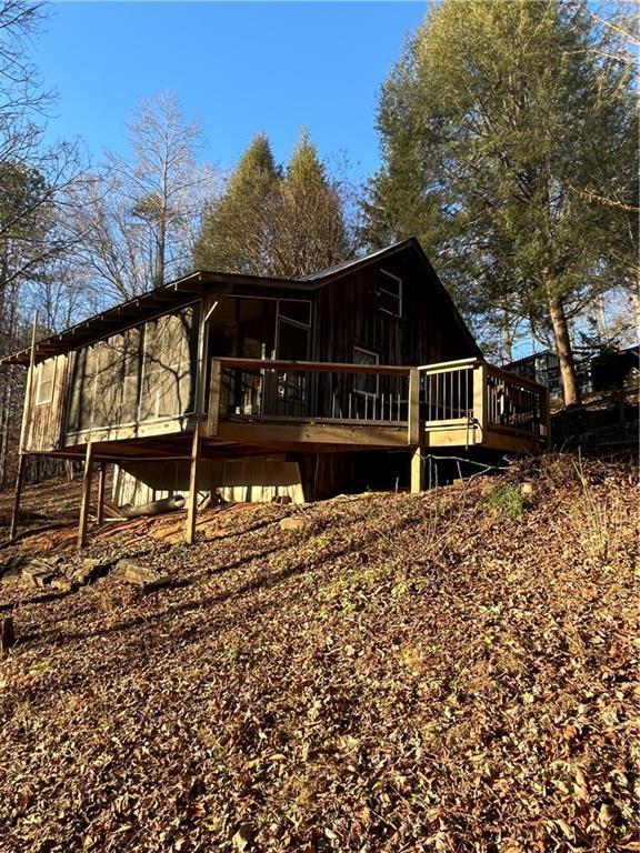 rear view of house with a wooden deck