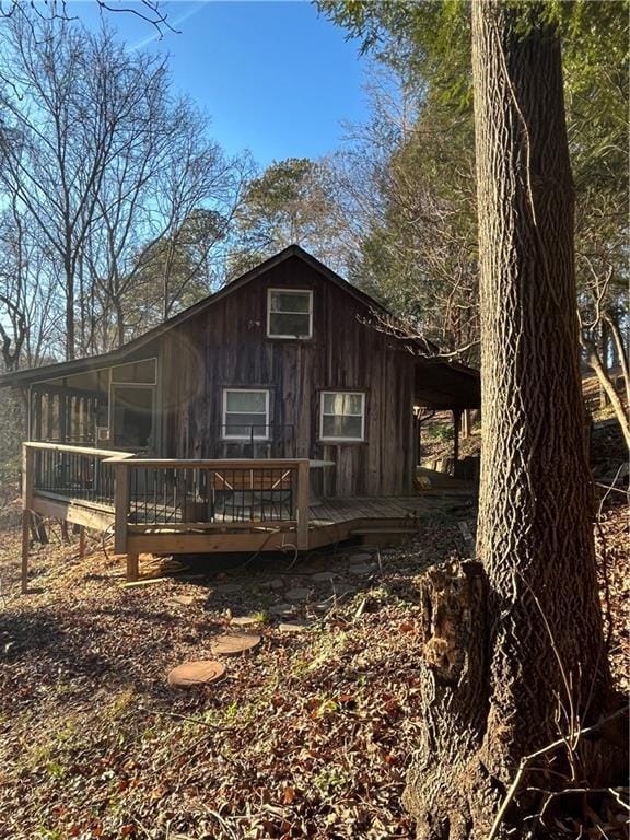 back of property featuring a wooden deck