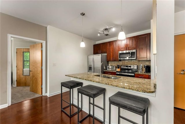 898 Oak St SW Unit 1301, Atlanta, GA 30310 - kitchen featuring appliances with stainless steel finishes, dark wood-style flooring, backsplash, a peninsula, and a breakfast bar area