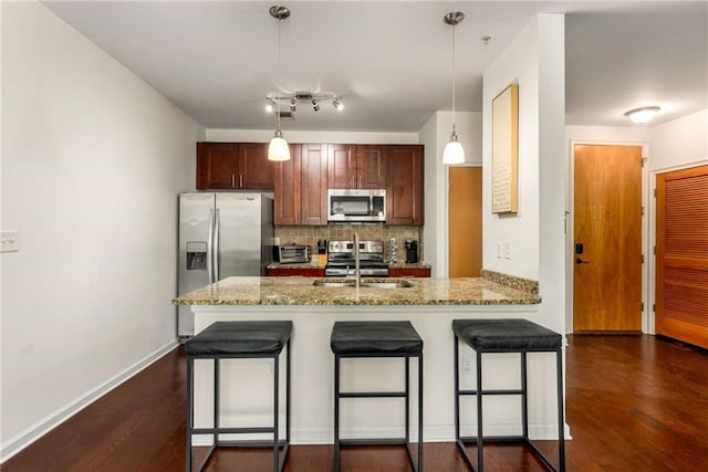 898 Oak St SW Unit 1301, Atlanta, GA 30310 - kitchen with stainless steel appliances, decorative backsplash, a peninsula, and dark wood finished floors