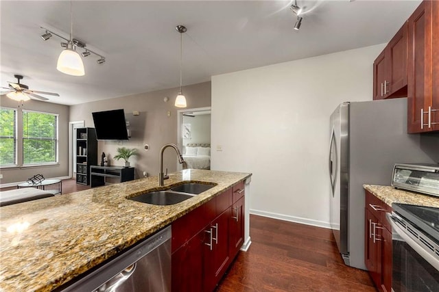 898 Oak St SW Unit 1301, Atlanta, GA 30310 - kitchen featuring appliances with stainless steel finishes, dark wood-style flooring, pendant lighting, ceiling fan, and light stone counters