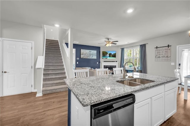 509 Azalea Bloom Dr, Loganville, GA 30052 - kitchen featuring stainless steel dishwasher, a ceiling fan, light wood-type flooring, white cabinets, and a sink