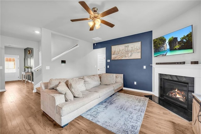 509 Azalea Bloom Dr, Loganville, GA 30052 - living area featuring baseboards, ceiling fan, wood finished floors, and a fireplace