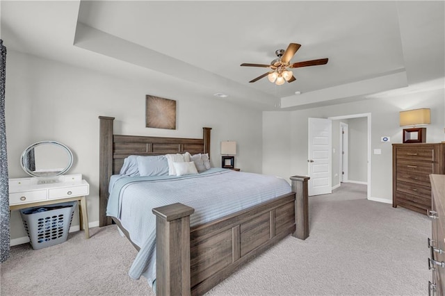509 Azalea Bloom Dr, Loganville, GA 30052 - bedroom with baseboards, a ceiling fan, a tray ceiling, and light carpet