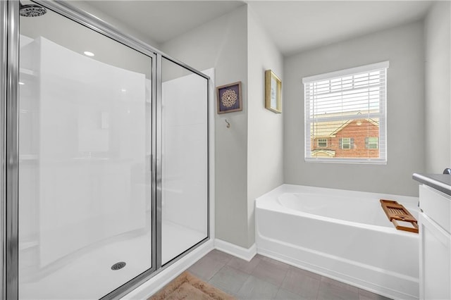 509 Azalea Bloom Dr, Loganville, GA 30052 - bathroom featuring baseboards, tile patterned floors, a bath, and a shower stall