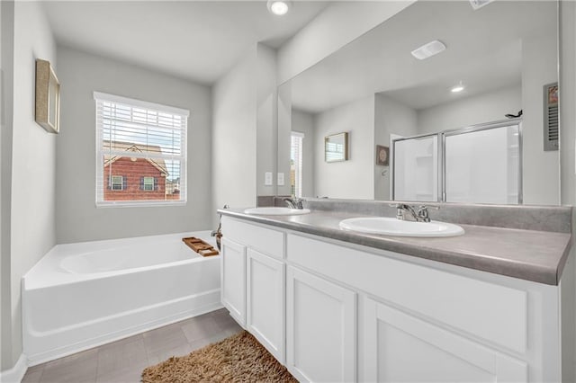 509 Azalea Bloom Dr, Loganville, GA 30052 - full bath with double vanity, a shower stall, a sink, and a garden tub