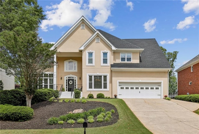 traditional home featuring stucco siding and concrete driveway