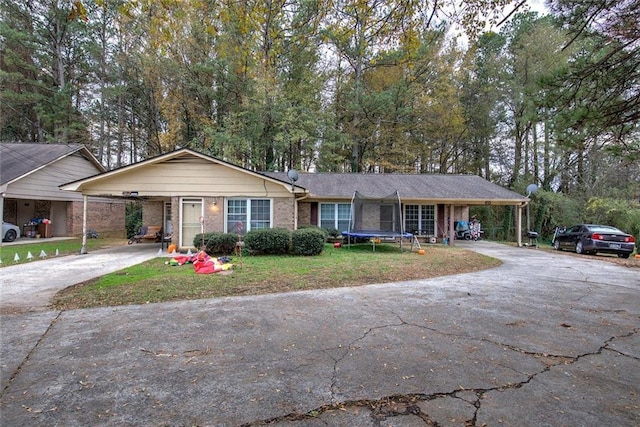 ranch-style home featuring a carport and a front lawn