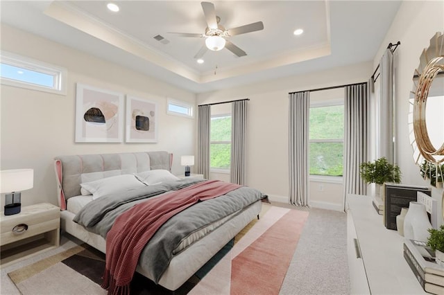 bedroom featuring recessed lighting, a raised ceiling, light carpet, and baseboards