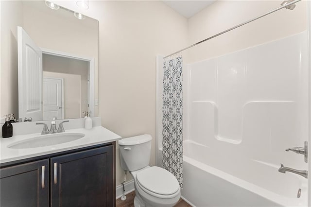 full bath featuring toilet, shower / bathtub combination with curtain, and vanity