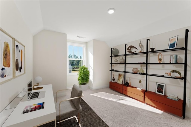 carpeted home office featuring lofted ceiling and visible vents