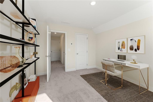 office featuring lofted ceiling, baseboards, and light colored carpet