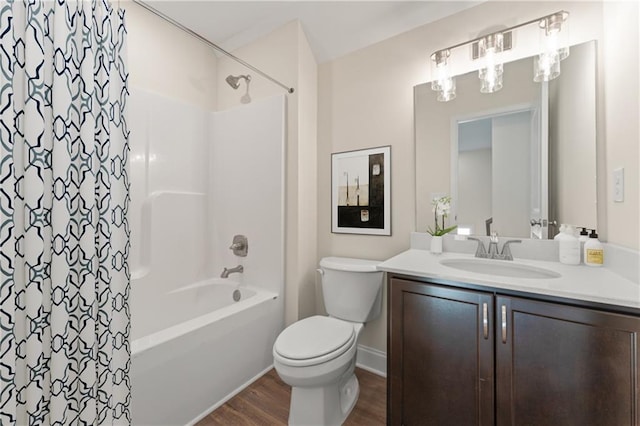 full bath with shower / tub combo with curtain, toilet, vanity, wood finished floors, and baseboards