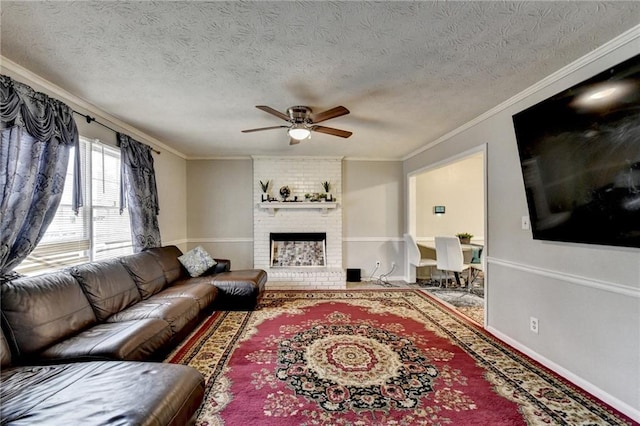 living room featuring a brick fireplace, crown molding, a textured ceiling, and ceiling fan