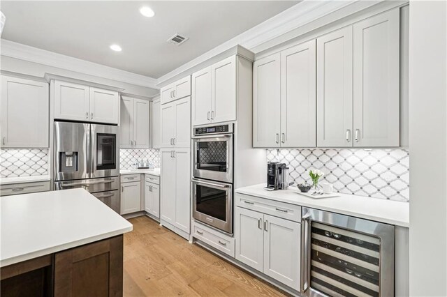 4025 Connolly Ct, Roswell, GA 30075 - kitchen with stainless steel appliances, beverage cooler, crown molding, recessed lighting, and tasteful backsplash