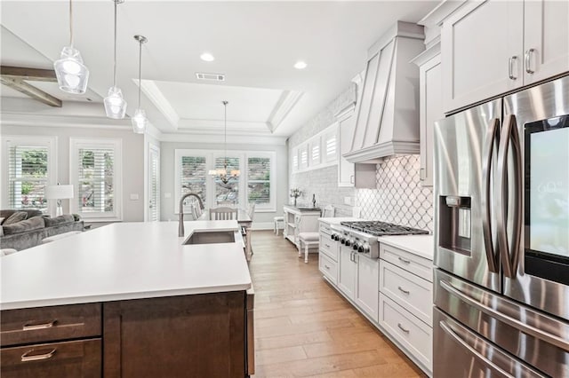 4025 Connolly Ct, Roswell, GA 30075 - kitchen featuring stainless steel appliances, custom exhaust hood, a sink, light countertops, and plenty of natural light