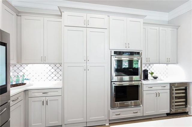 4025 Connolly Ct, Roswell, GA 30075 - kitchen with wine cooler, double oven, light countertops, backsplash, and crown molding