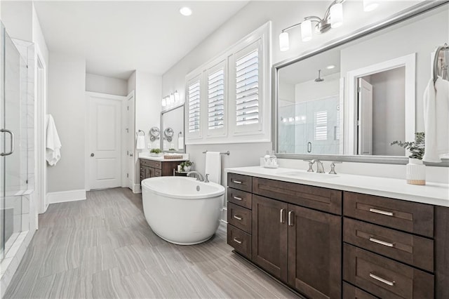 4025 Connolly Ct, Roswell, GA 30075 - bathroom featuring a shower stall, two vanities, and a freestanding tub