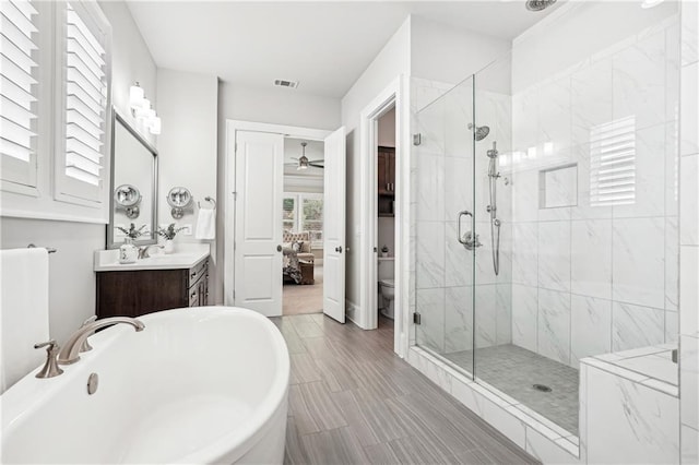 4025 Connolly Ct, Roswell, GA 30075 - ensuite bathroom with a freestanding tub, a marble finish shower, vanity, a ceiling fan, and toilet