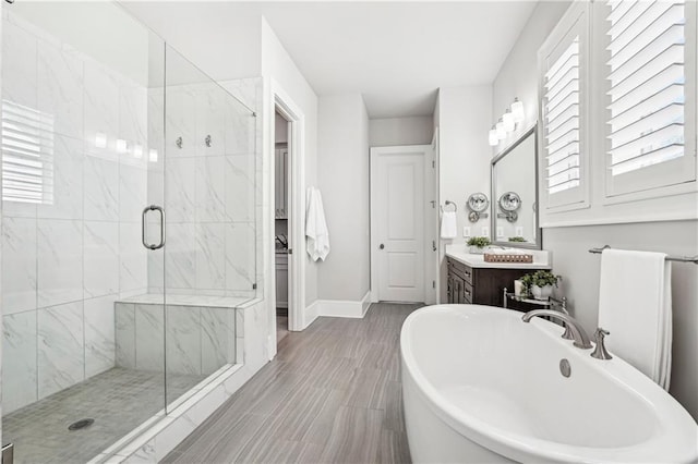 4025 Connolly Ct, Roswell, GA 30075 - bathroom with a freestanding bath, a marble finish shower, vanity, and healthy amount of natural light