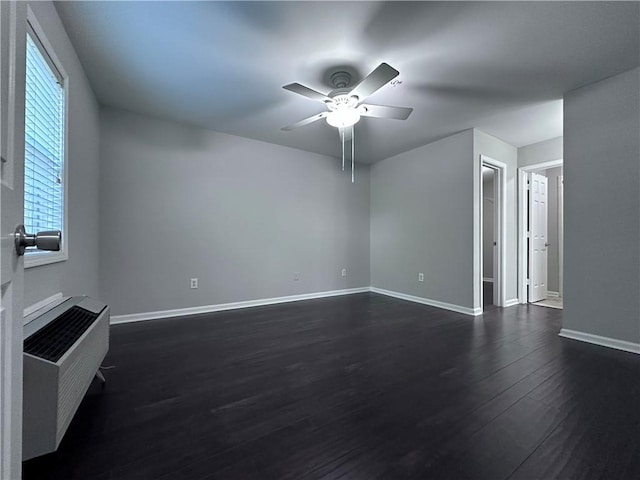 unfurnished living room with ceiling fan and dark hardwood / wood-style flooring