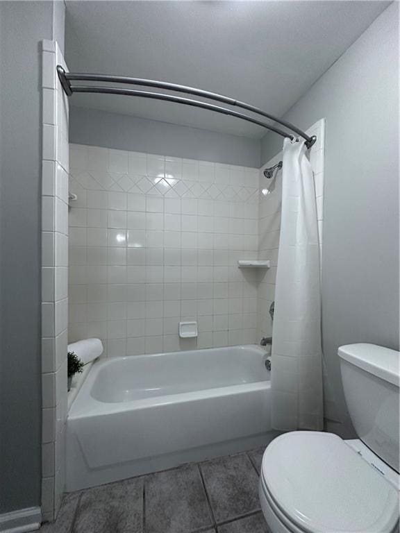 bathroom featuring tile patterned flooring, shower / bath combination with curtain, and toilet