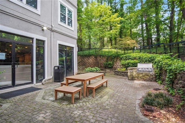 4244 River Green Dr NW Unit 111, Atlanta, GA 30327 - view of patio with area for grilling, an outdoor kitchen, a fenced backyard, and outdoor dining space