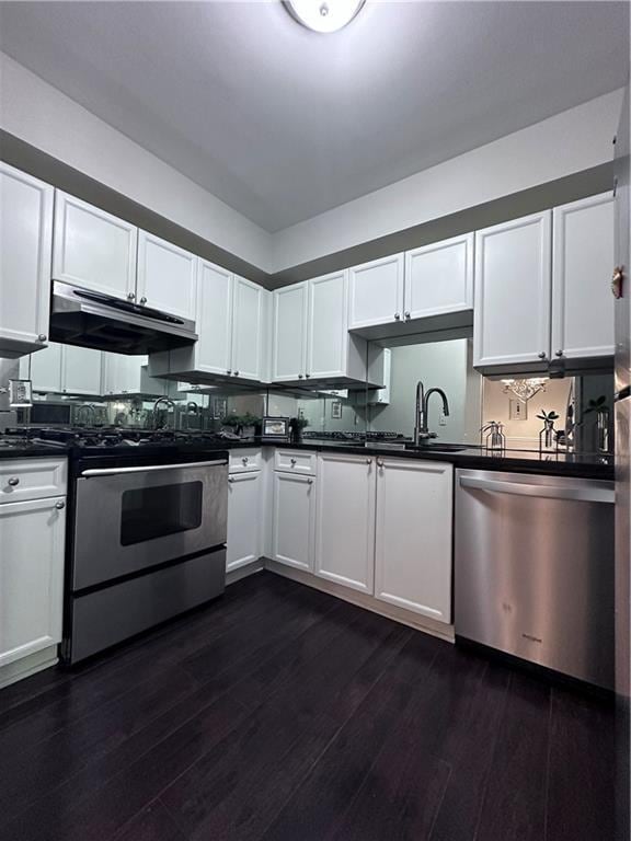 kitchen with white cabinetry, stainless steel appliances, dark hardwood / wood-style flooring, and sink