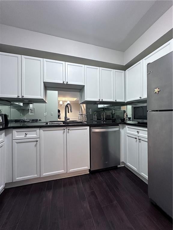 4244 River Green Dr NW Unit 111, Atlanta, GA 30327 - kitchen featuring a sink, appliances with stainless steel finishes, dark countertops, and white cabinetry