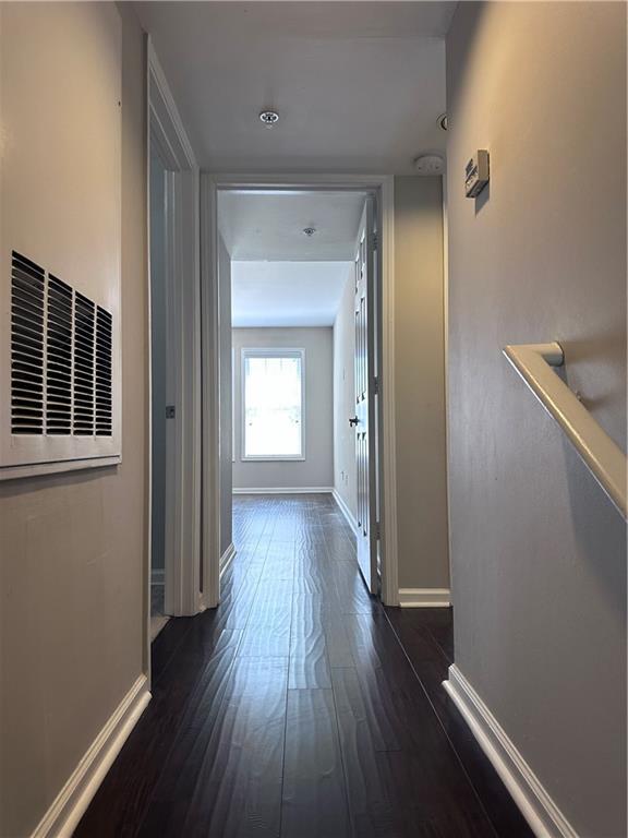 corridor featuring dark wood-type flooring