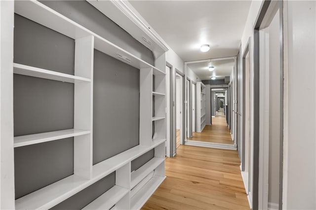 hallway with hardwood / wood-style flooring