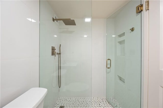 bathroom featuring a shower with shower door