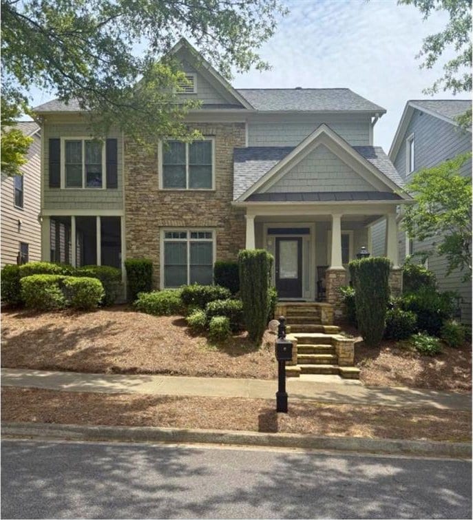 4845 Backbay St, Suwanee, GA 30024 - craftsman-style house featuring a porch and stone siding